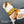 French Bulldog wearing a size M yellow harness with VCU logo on a gray pavement background